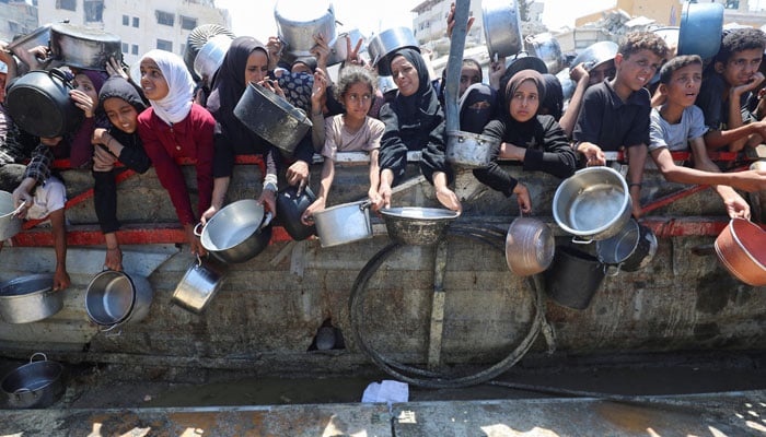 Palestinians wait to receive food from a charity kitchen, amid a hunger crisis, in Gaza City, August 2, 2025. — Reuters