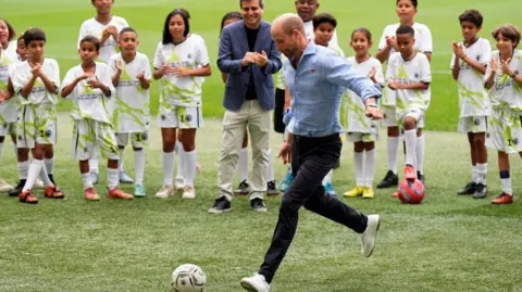 PA Media Prince William taking a penalty